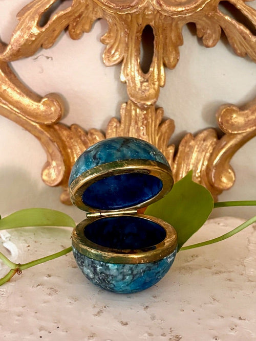 Blue marbled sphere trinket box open on a brass hinge with a cobalt interior.