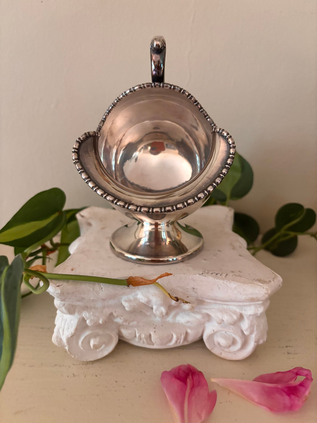 Interior view of silver-plate sugar scuttle showing plain polished bowl and beaded rim border.