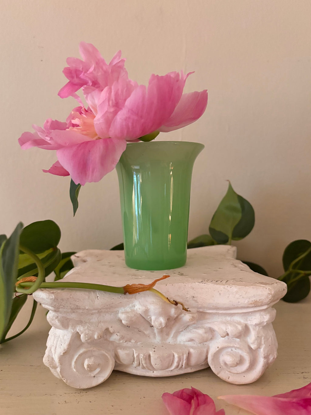 Small opaque mint green jadeite glass tumbler with tapered cylindrical body and gently flared rim.