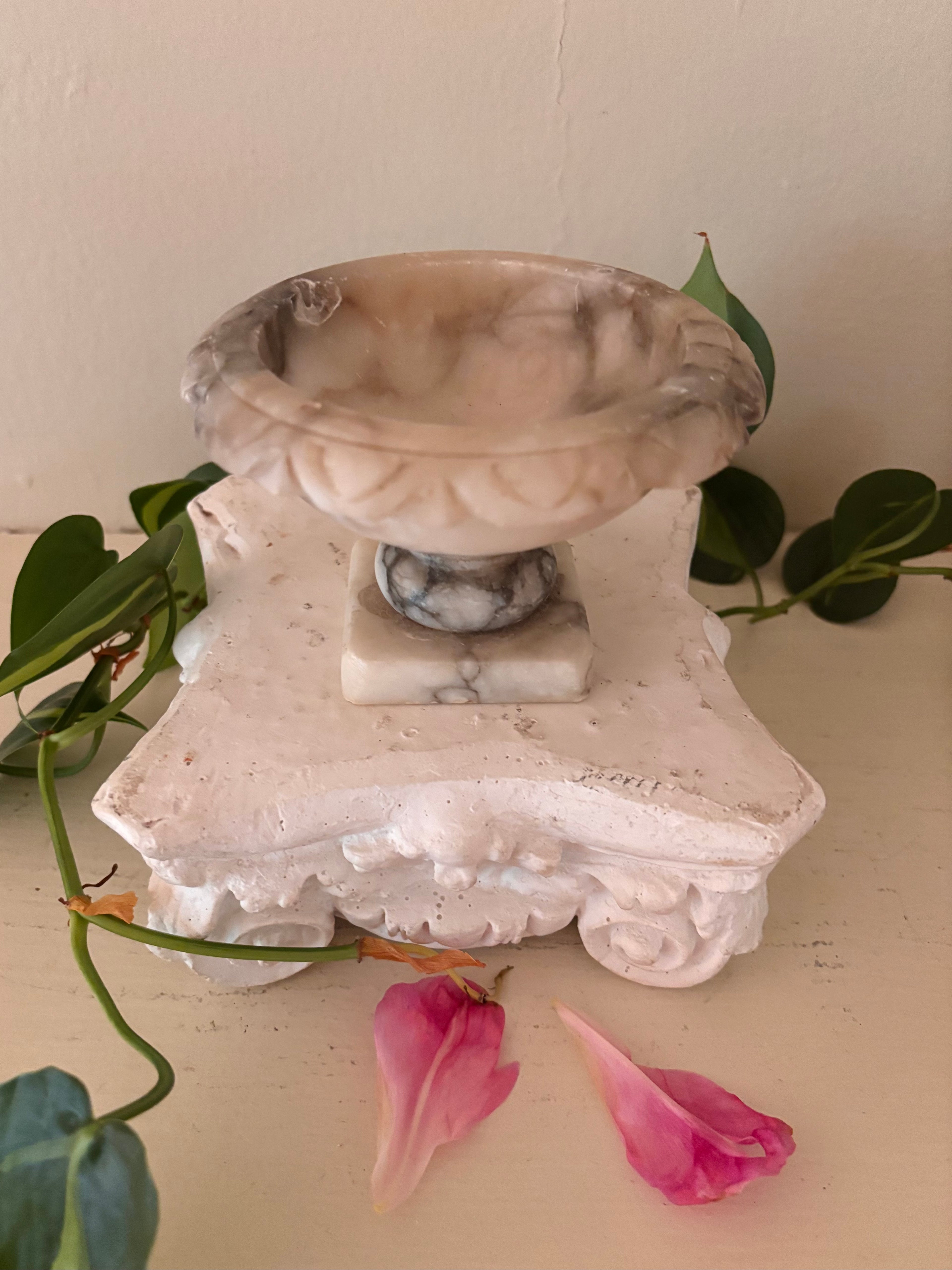 Marble footed compote with carved petal rim, cream and charcoal grey veined stone, short turned pedestal.