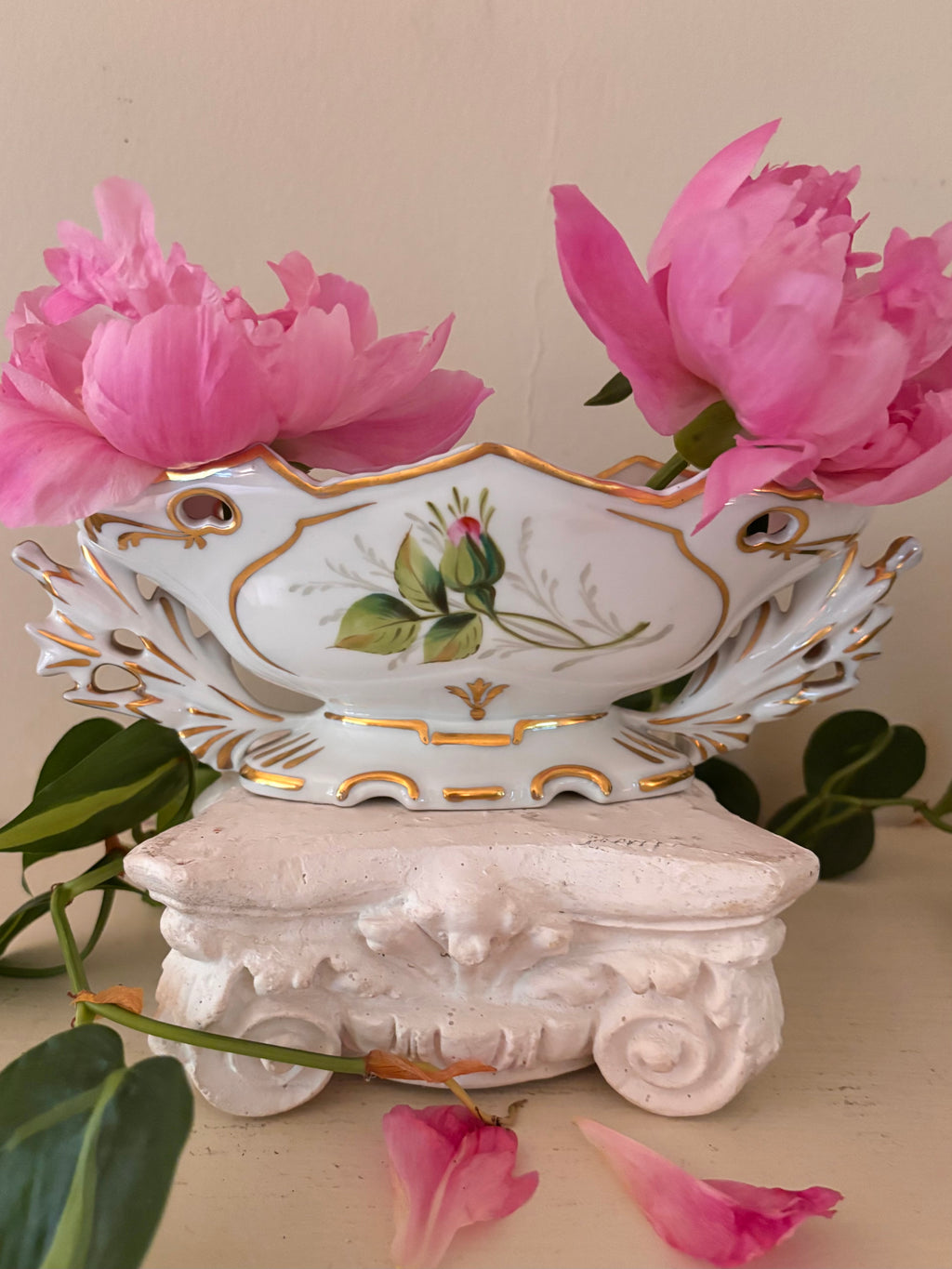 White porcelain centerpiece bowl with hand-painted floral bouquet cartouche and gilt acanthus handles.