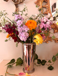 Tall silver vase with vertical ribbing, polished silver finish, and rounded foot base.