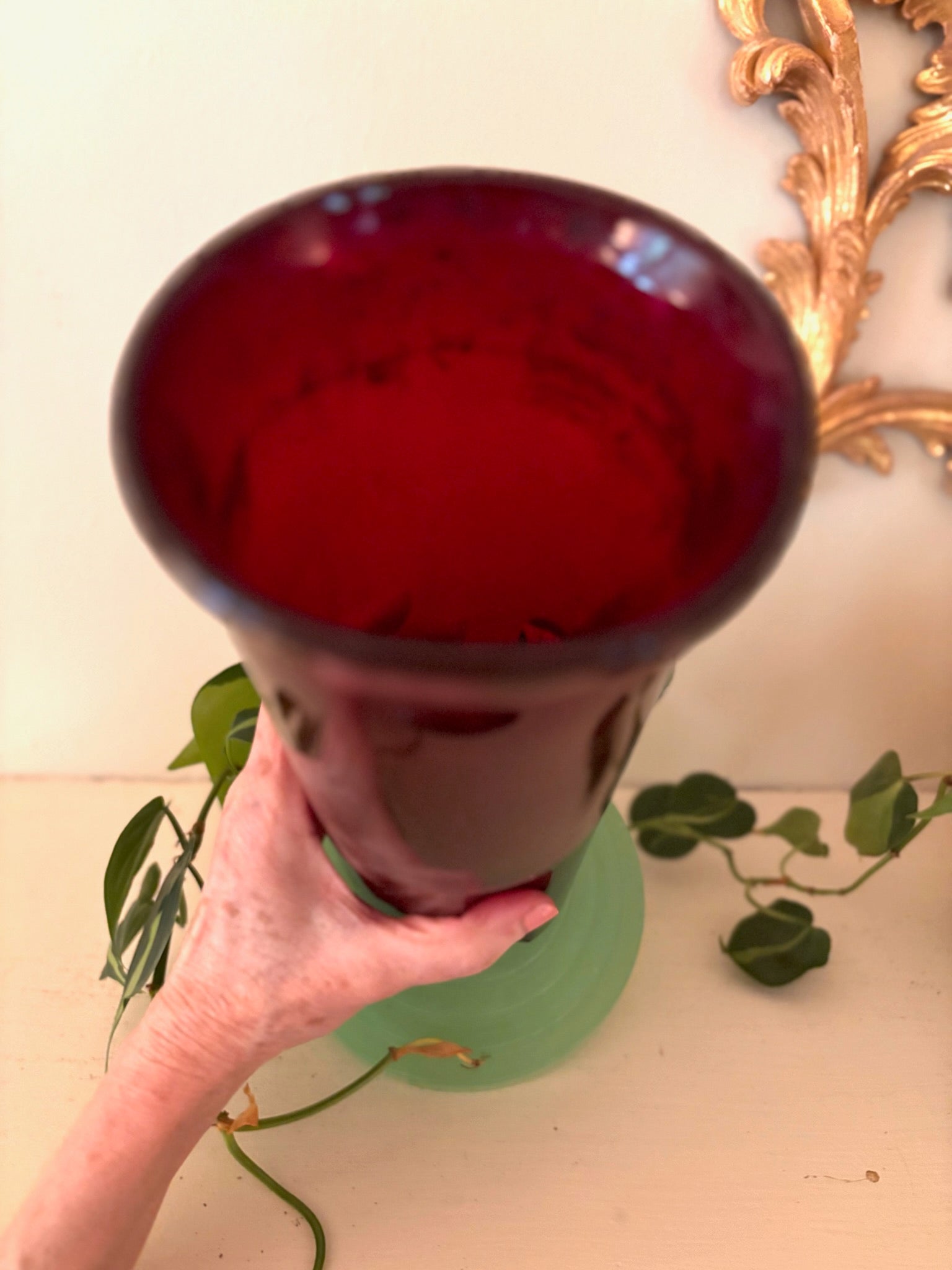 Top-down view of wide-mouthed ruby glass vase showing thick glass walls and deep red color.