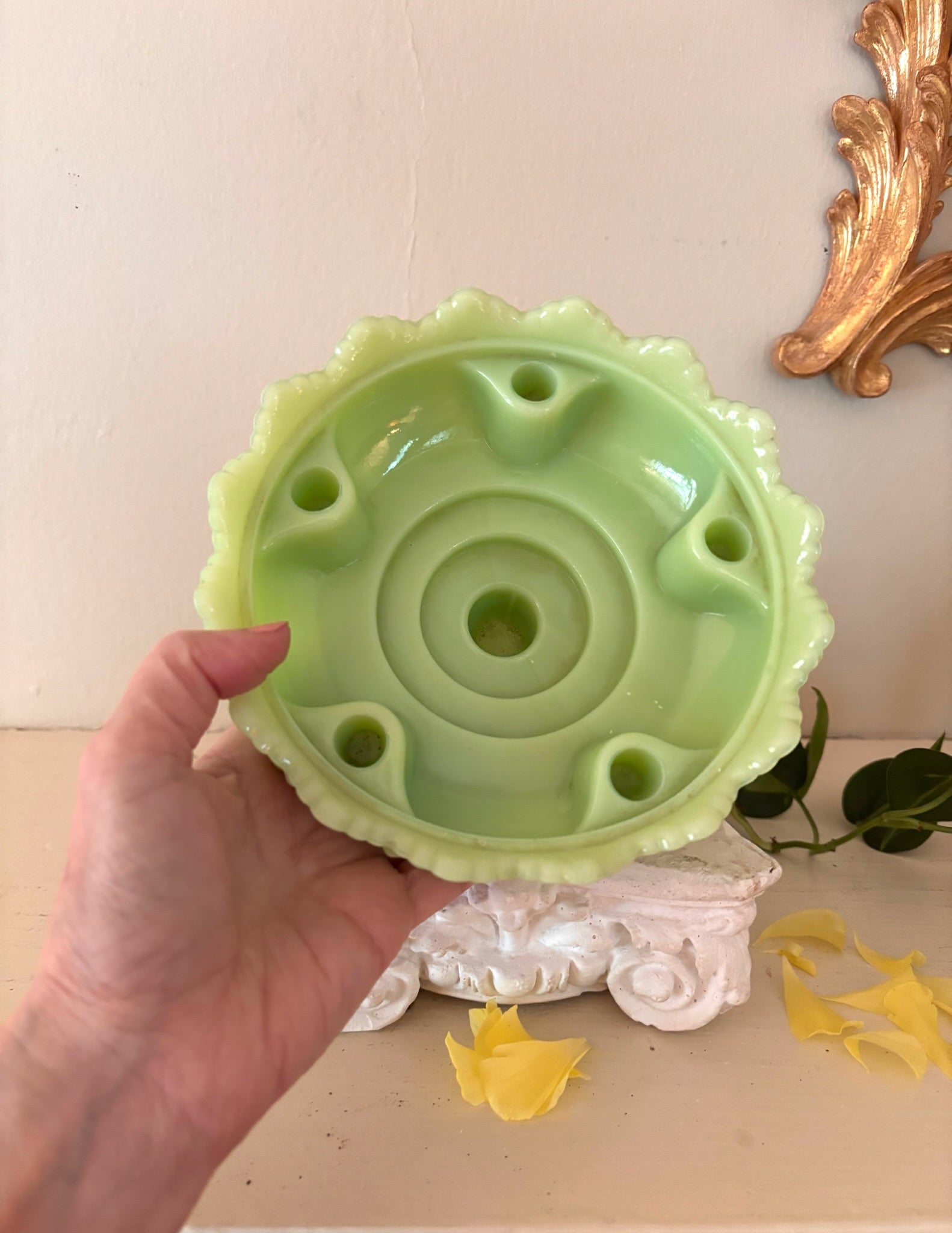 Interior of jadeite Fenton compote showing flower frog holes arranged around central stem hole.
