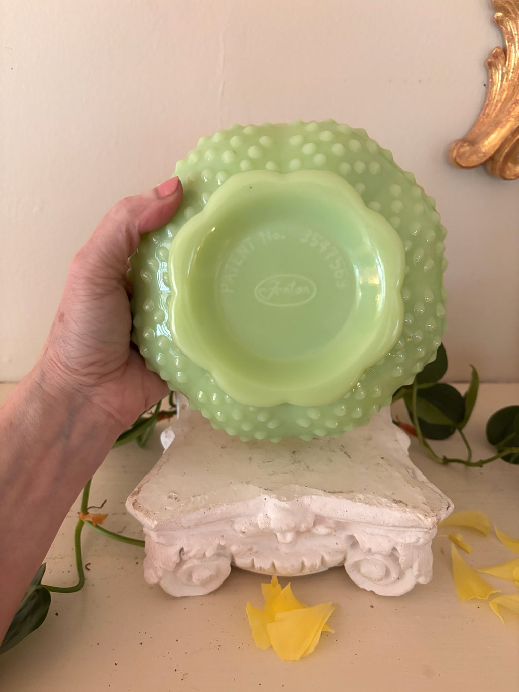 Base of Fenton jadeite hobnail compote showing Fenton oval maker's mark and patent number.