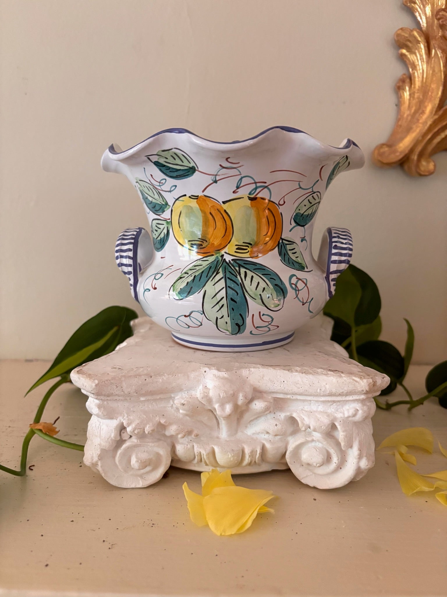 Front view of Italian hand-painted cachepot showing citrus motif side, blue stripe base and scalloped rim.