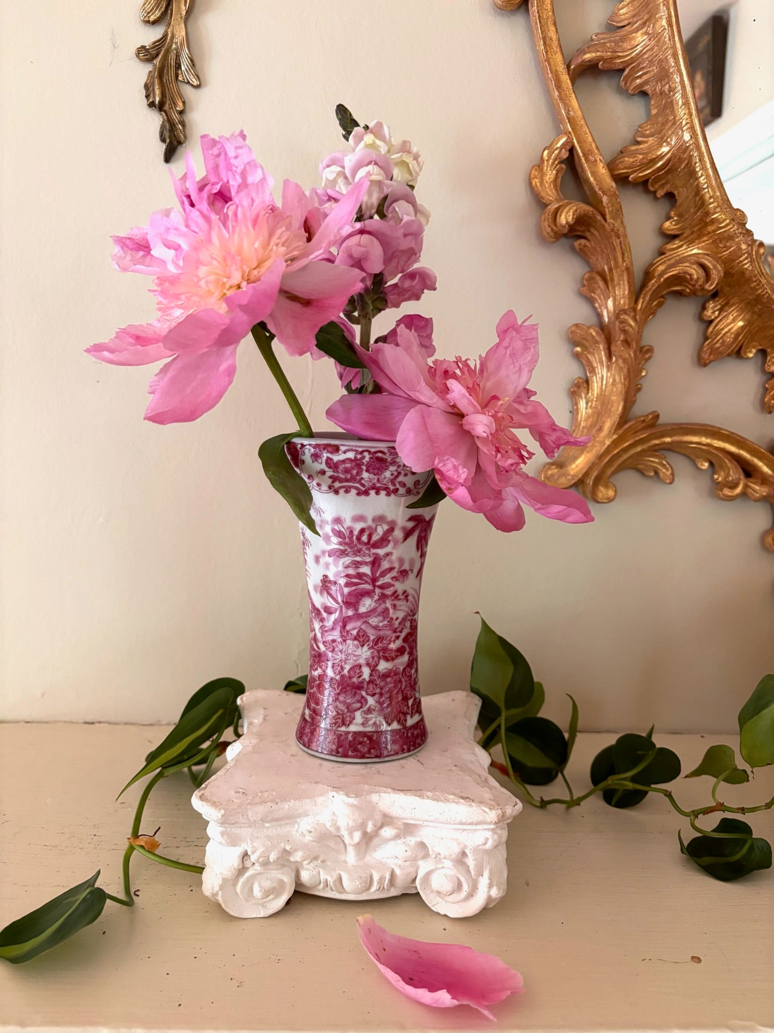 Antique trumpet-form porcelain vase with raspberry pink chinoiserie scene and scrollwork border at rim.