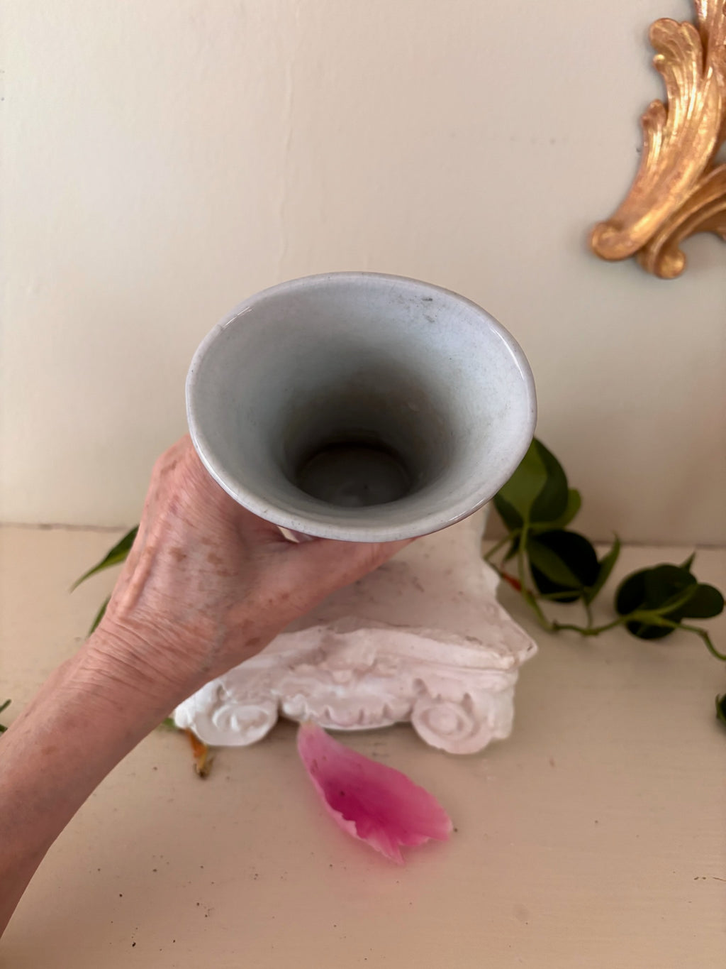 Interior view of trumpet-form porcelain vase showing white glaze and narrow funnel shape.