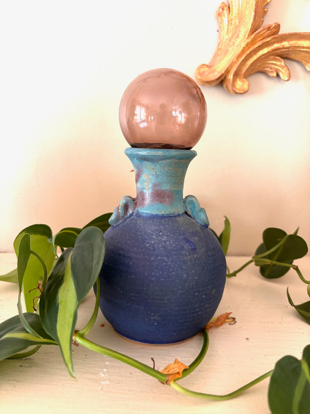 Handmade Puerto Rican studio pottery vase with matte violet body and teal flared neck.