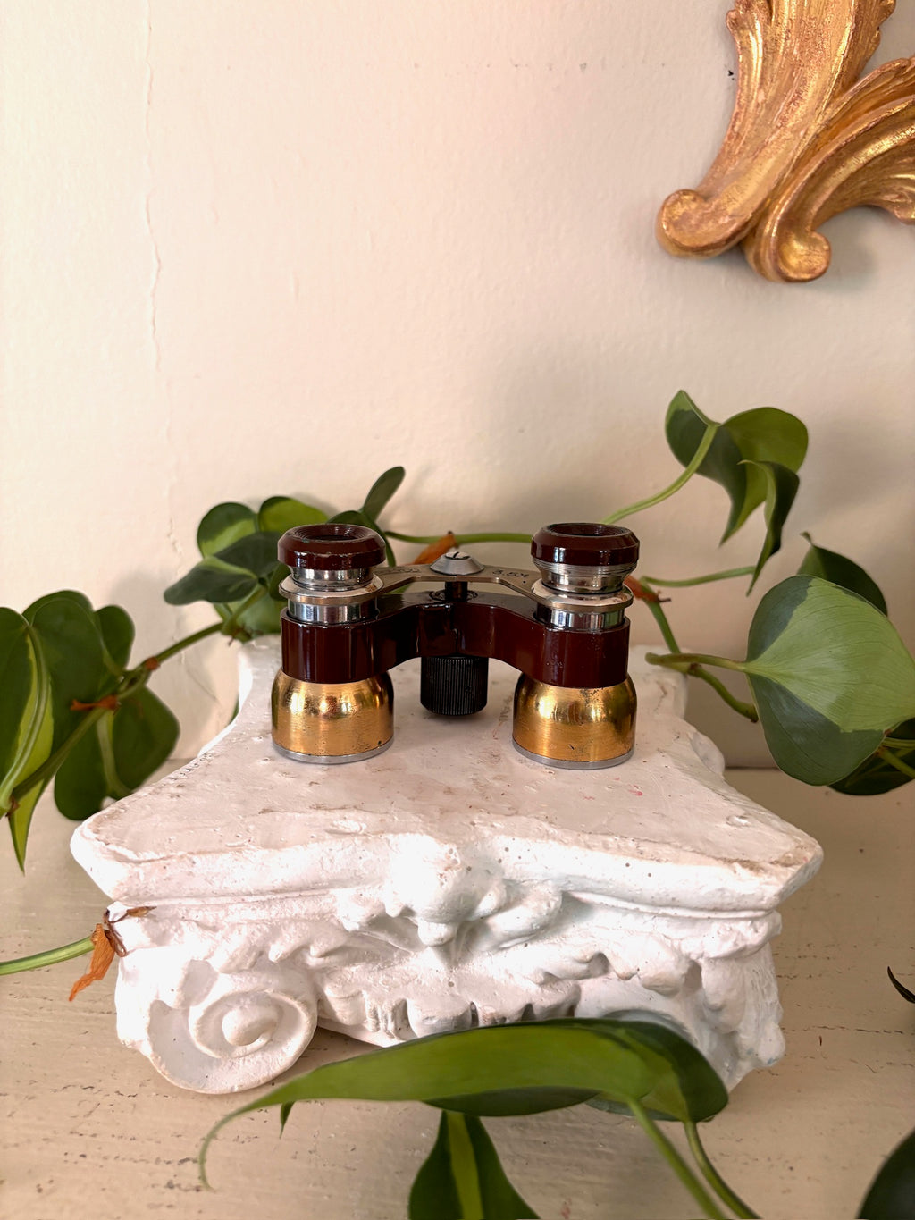  Brass-bridged opera glasses marked POLYCO and 3.5x with oxblood enamel barrels and a center focus screw.