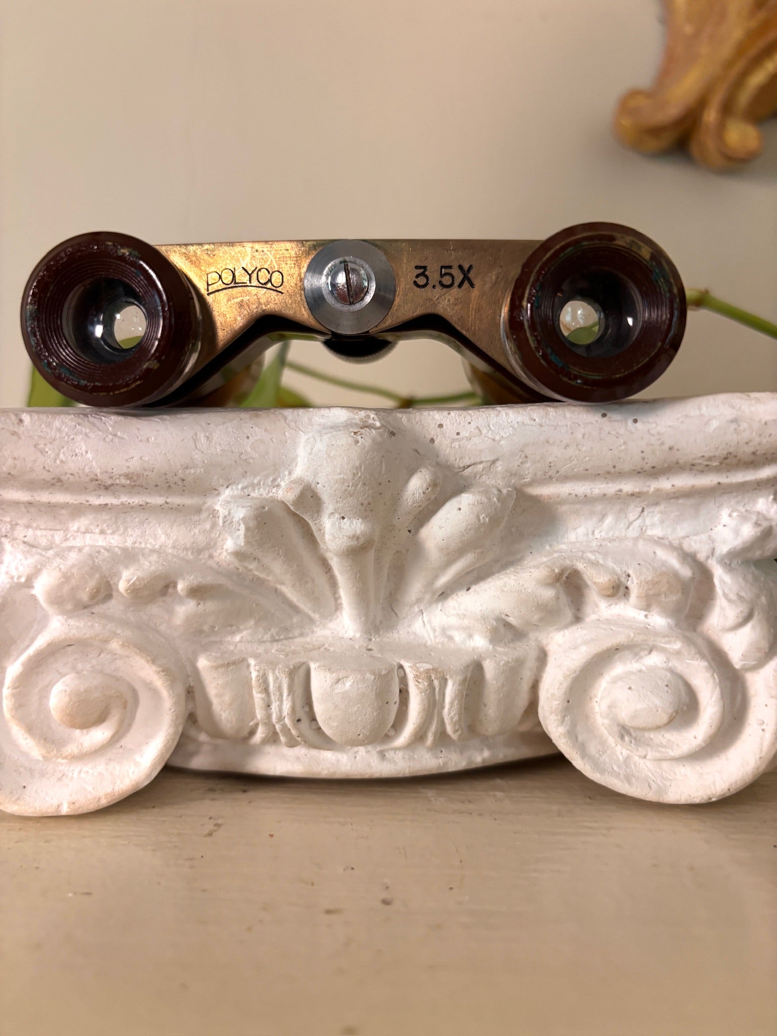 Oxblood enamel and gilt brass opera glasses with chrome rings and a black center focus wheel.