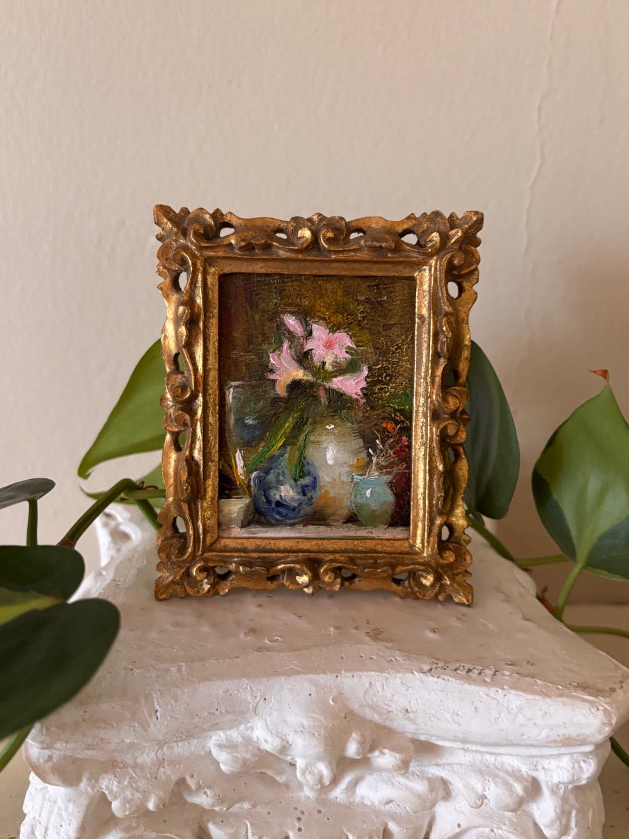 Miniature impressionist floral oil painting depicting pink blooms and small vases in loose expressive brushwork, set in an ornate carved gilt Florentine frame with pierced scrollwork corners