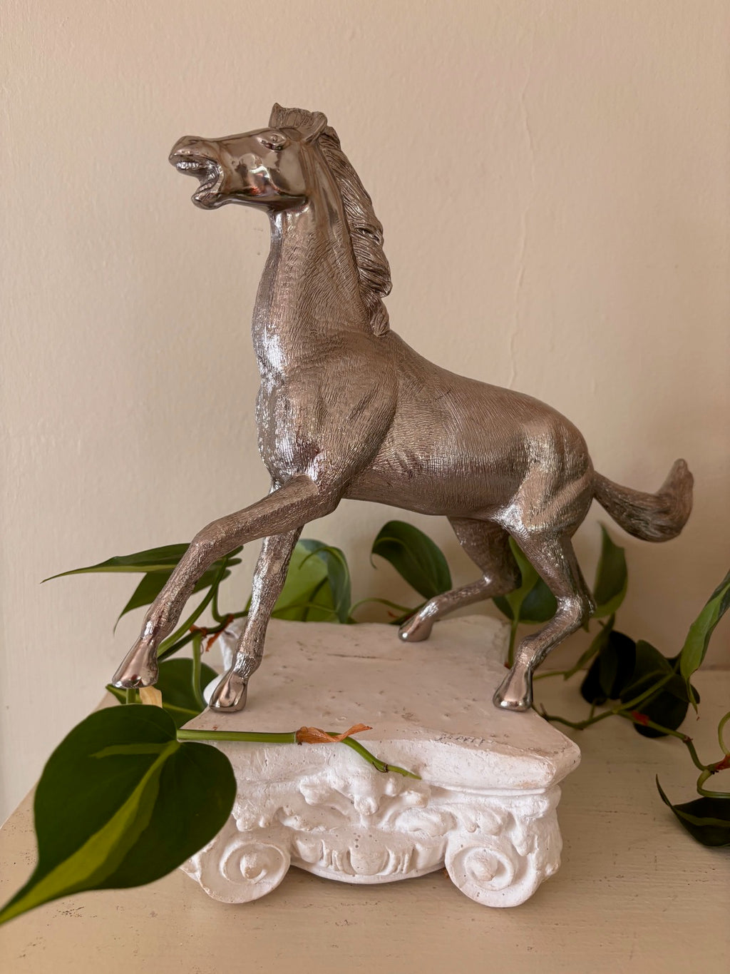 Silver-finish rearing horse sculpture with highly detailed engraved coat texture and polished face, in a dynamic pose with front legs raised and mouth open
