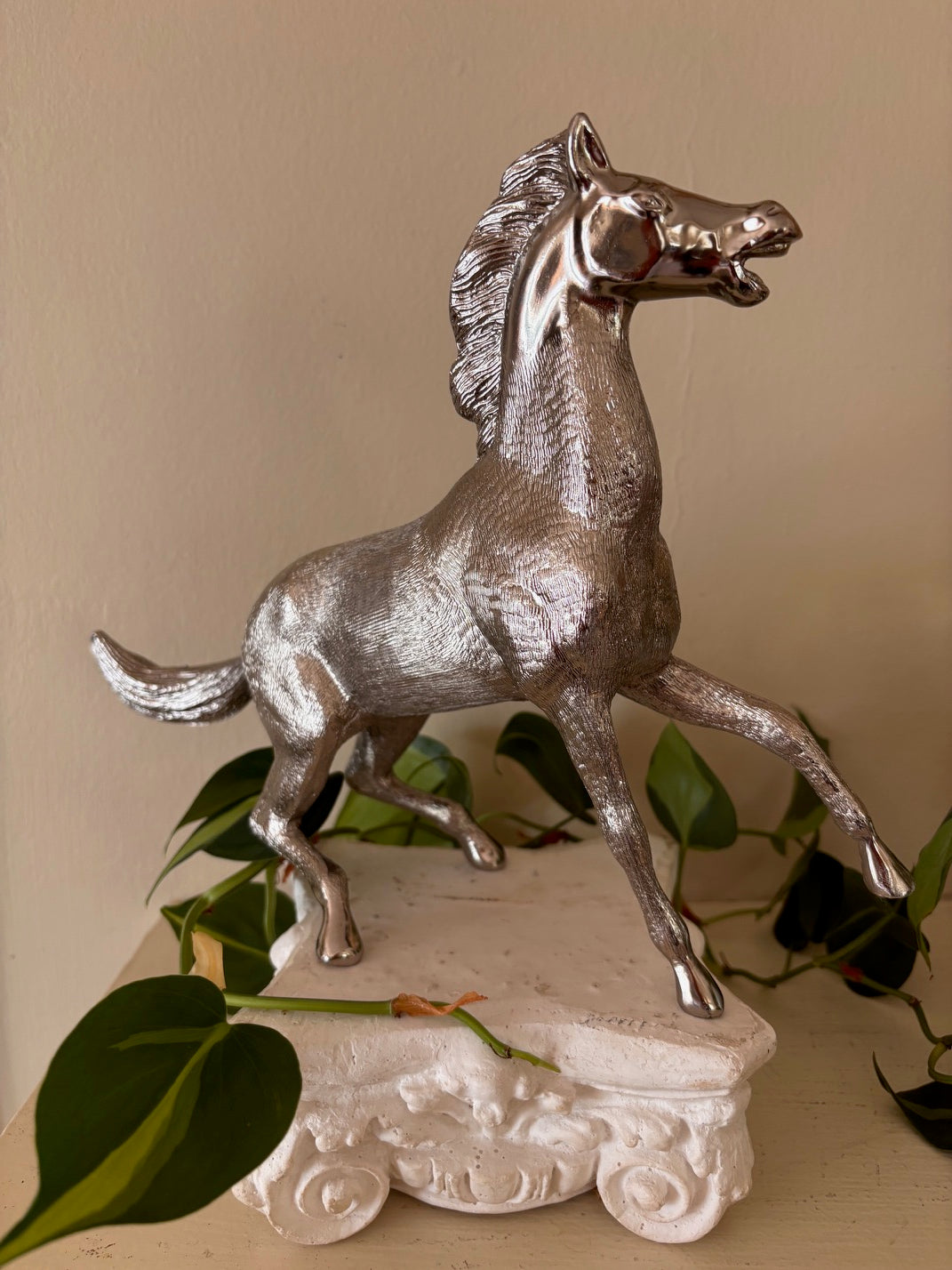 Silver-finish rearing horse sculpture with highly detailed engraved coat texture and polished face, in a dynamic pose with front legs raised and mouth open