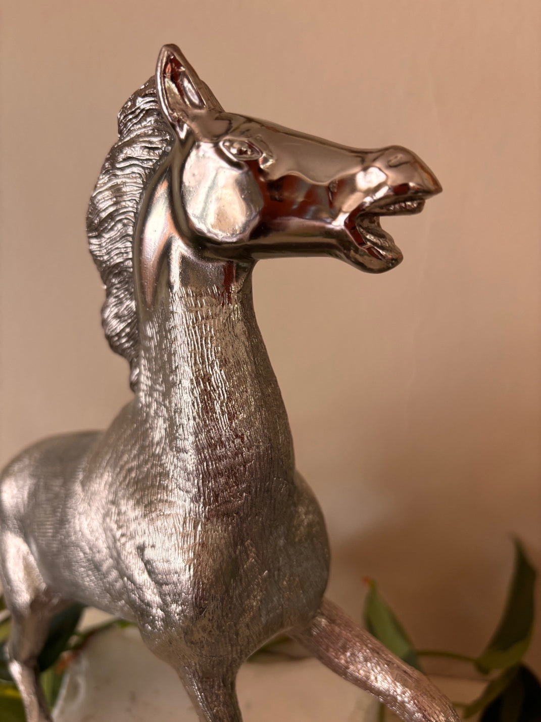 Silver-finish rearing horse sculpture with highly detailed engraved coat texture and polished face, in a dynamic pose with front legs raised and mouth open