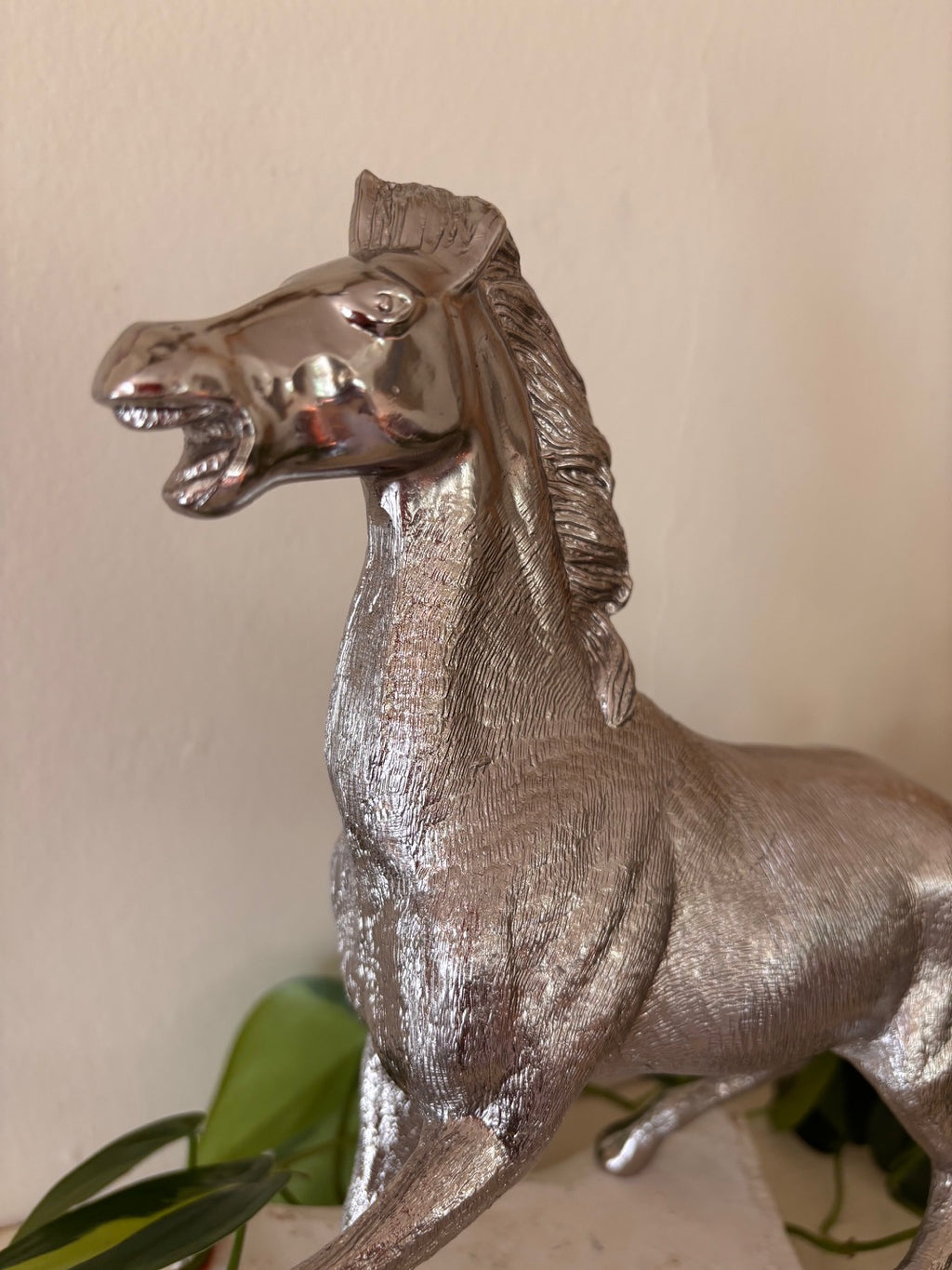 Silver-finish rearing horse sculpture with highly detailed engraved coat texture and polished face, in a dynamic pose with front legs raised and mouth open