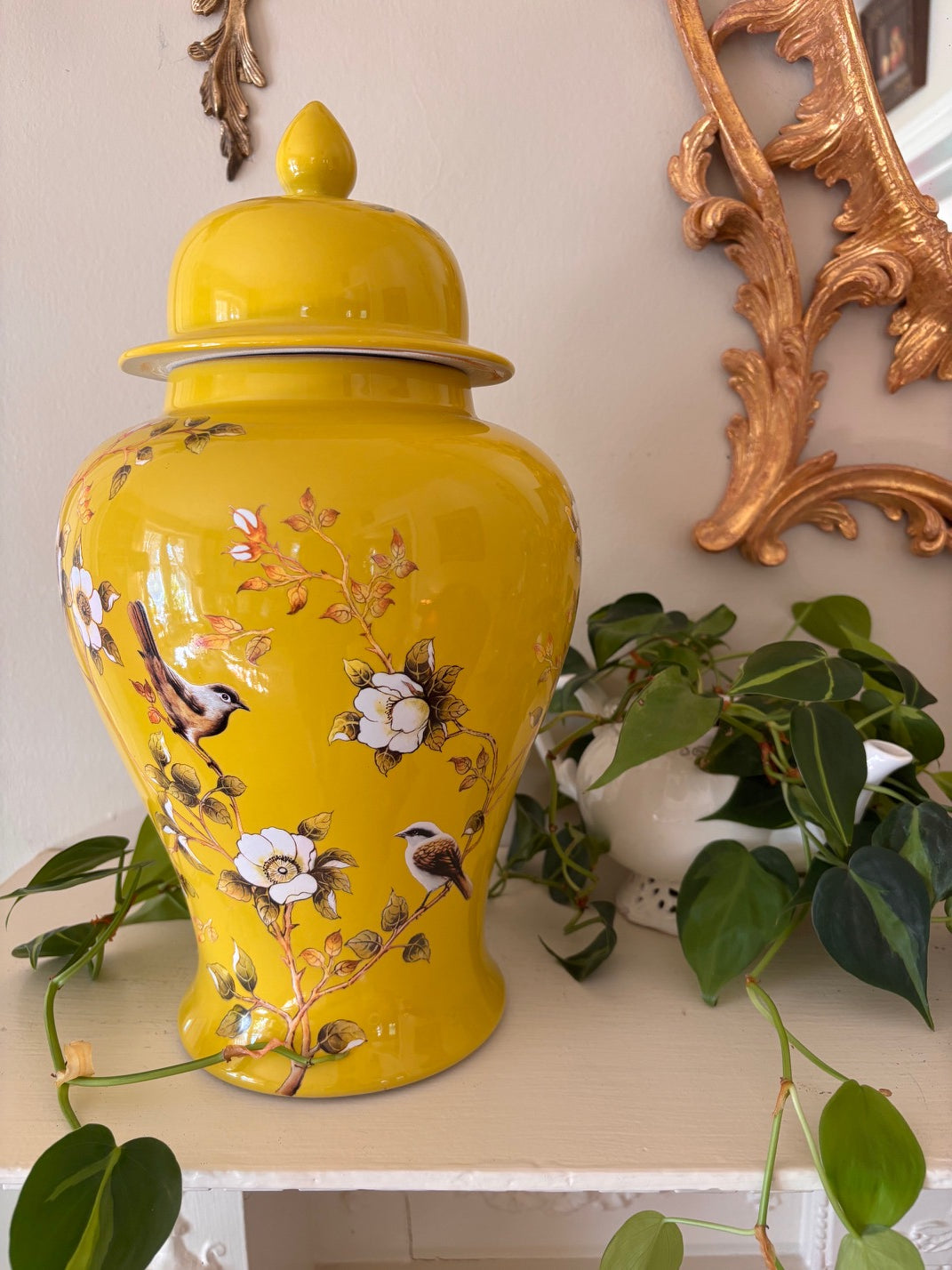 Large lidded ginger jar with vivid imperial yellow ground decorated with painted songbirds on flowering branches in Chinoiserie style, with domed lid and pointed finial.