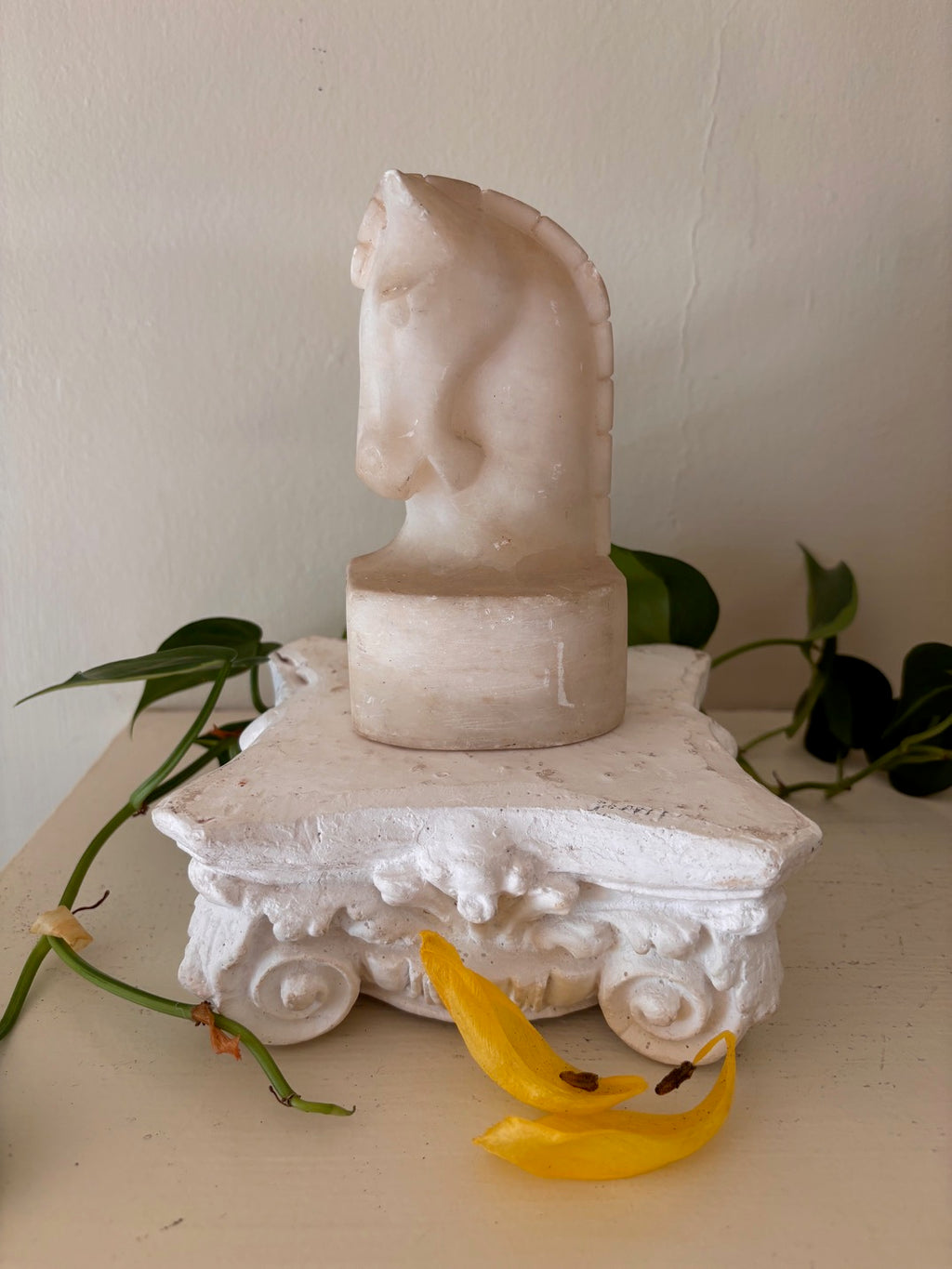 Carved alabaster horse head sculpture in warm cream and white tones with stylized mane and arched neck on an integral oval base — part of the Lunarly Home Derby Collection