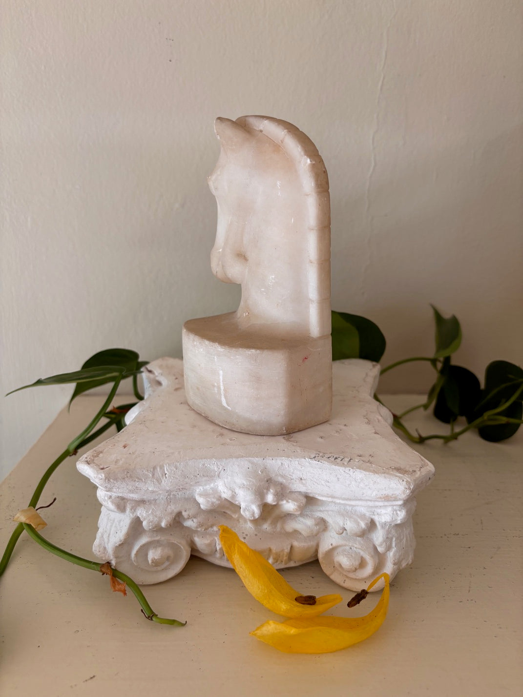 Carved alabaster horse head sculpture in warm cream and white tones with stylized mane and arched neck on an integral oval base — part of the Lunarly Home Derby Collection