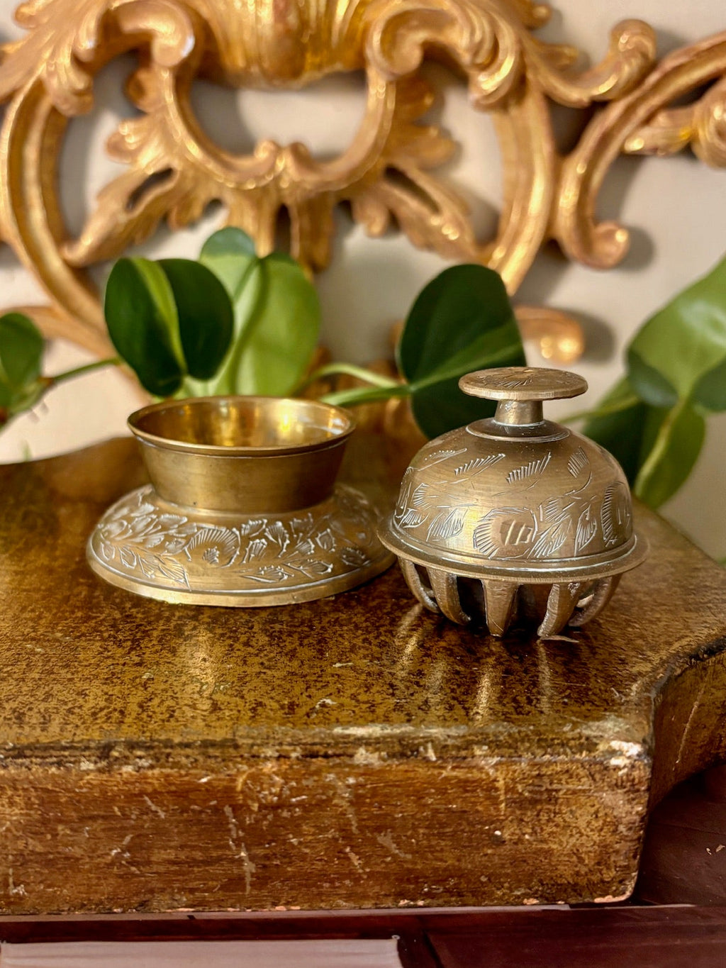 Brass inkwell lid removed, showing the ribbed interior cage and brass ink cup in the base.