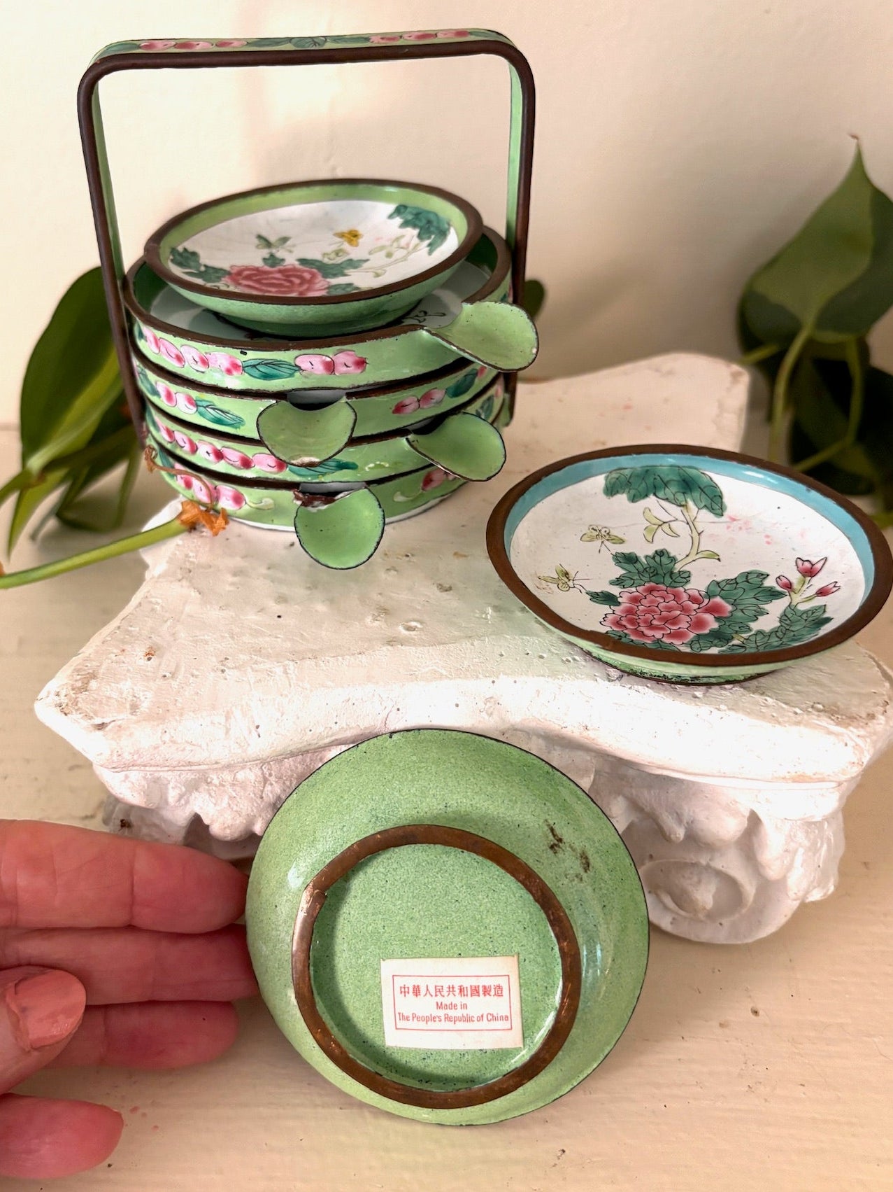 Underside of a green Canton enamel dish with a red "Made in People's Republic of China" label.