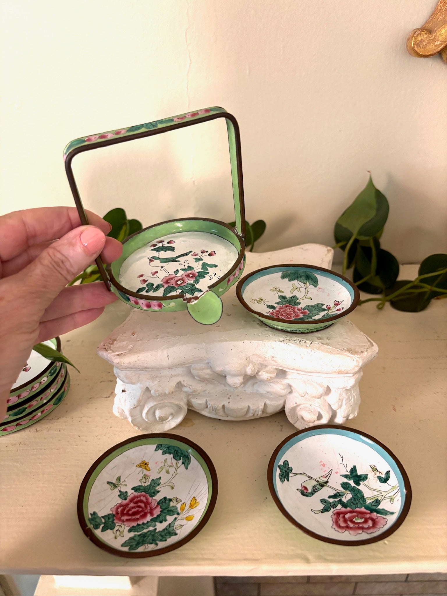 Green enamel handled basket with hand-painted Canton enamel dishes showing birds, peonies, and butterflies.