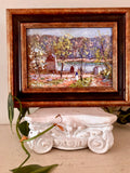 Small oil landscape painting of a red barn and pond framed by autumn trees, in a bronze wood frame.