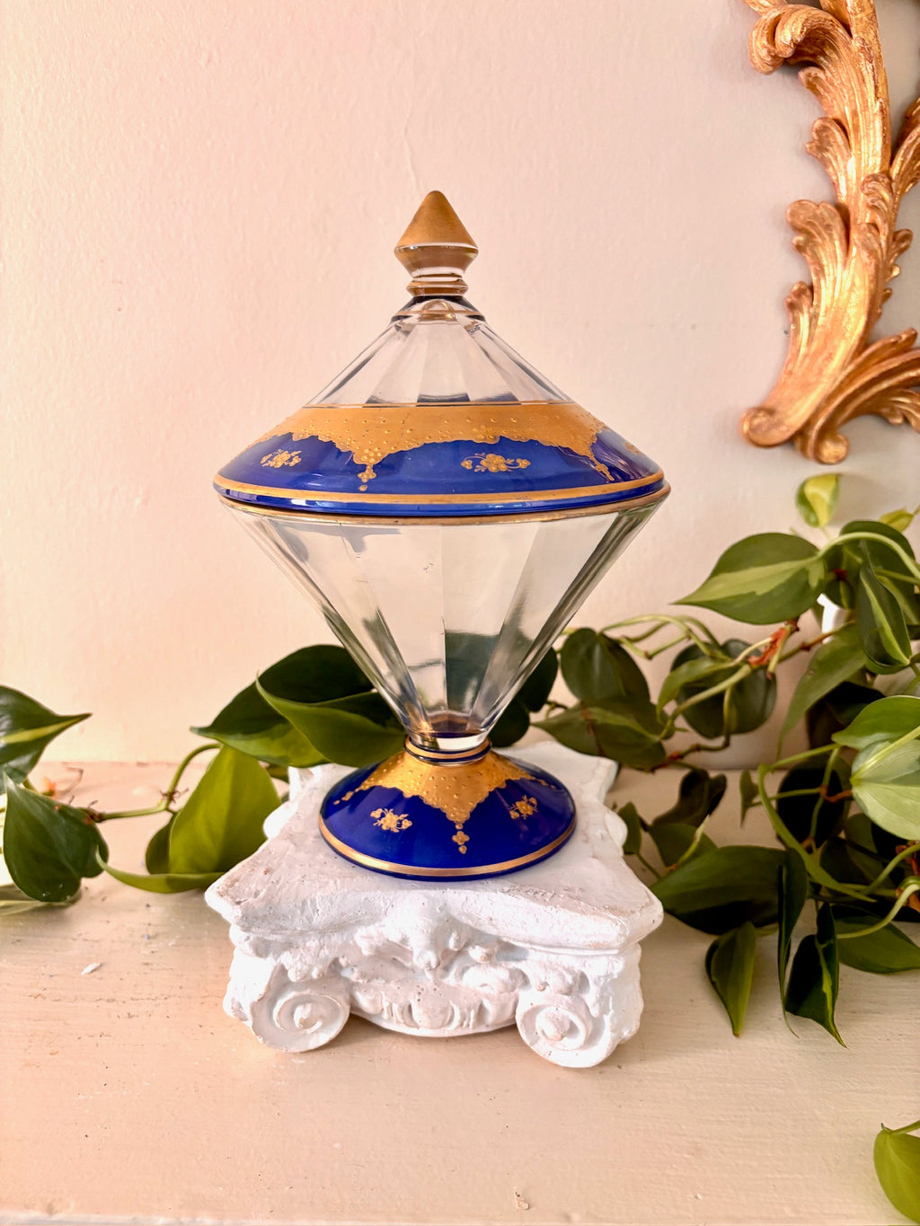 Side view of faceted glass lidded compote with cobalt and gold banding and pointed finial.