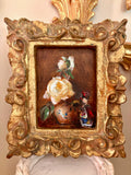 Small oil still life painting of white roses and a ceramic vase in a carved gilt frame.