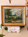 il landscape painting of a blossoming spring wood with a wood fence, in a gilt frame.
