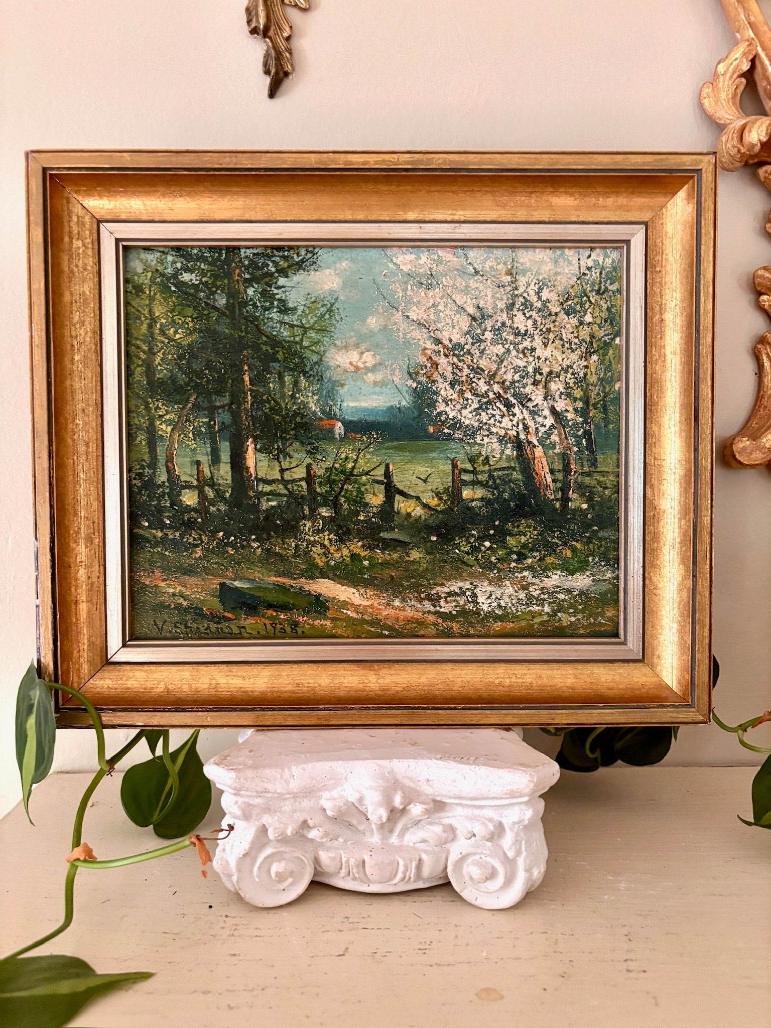 il landscape painting of a blossoming spring wood with a wood fence, in a gilt frame.