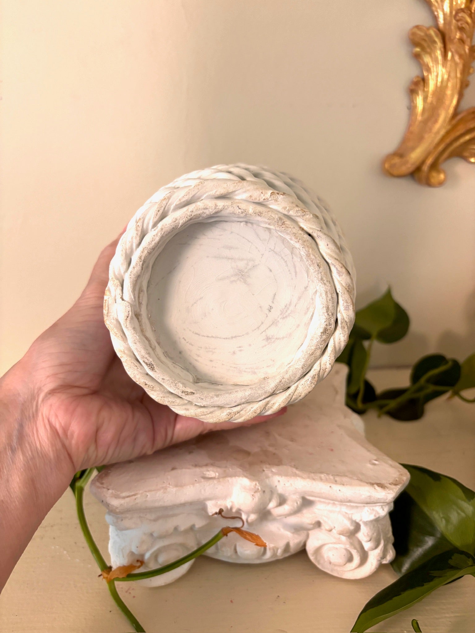 Base of the white woven ceramic basket showing the rope-twist foot.