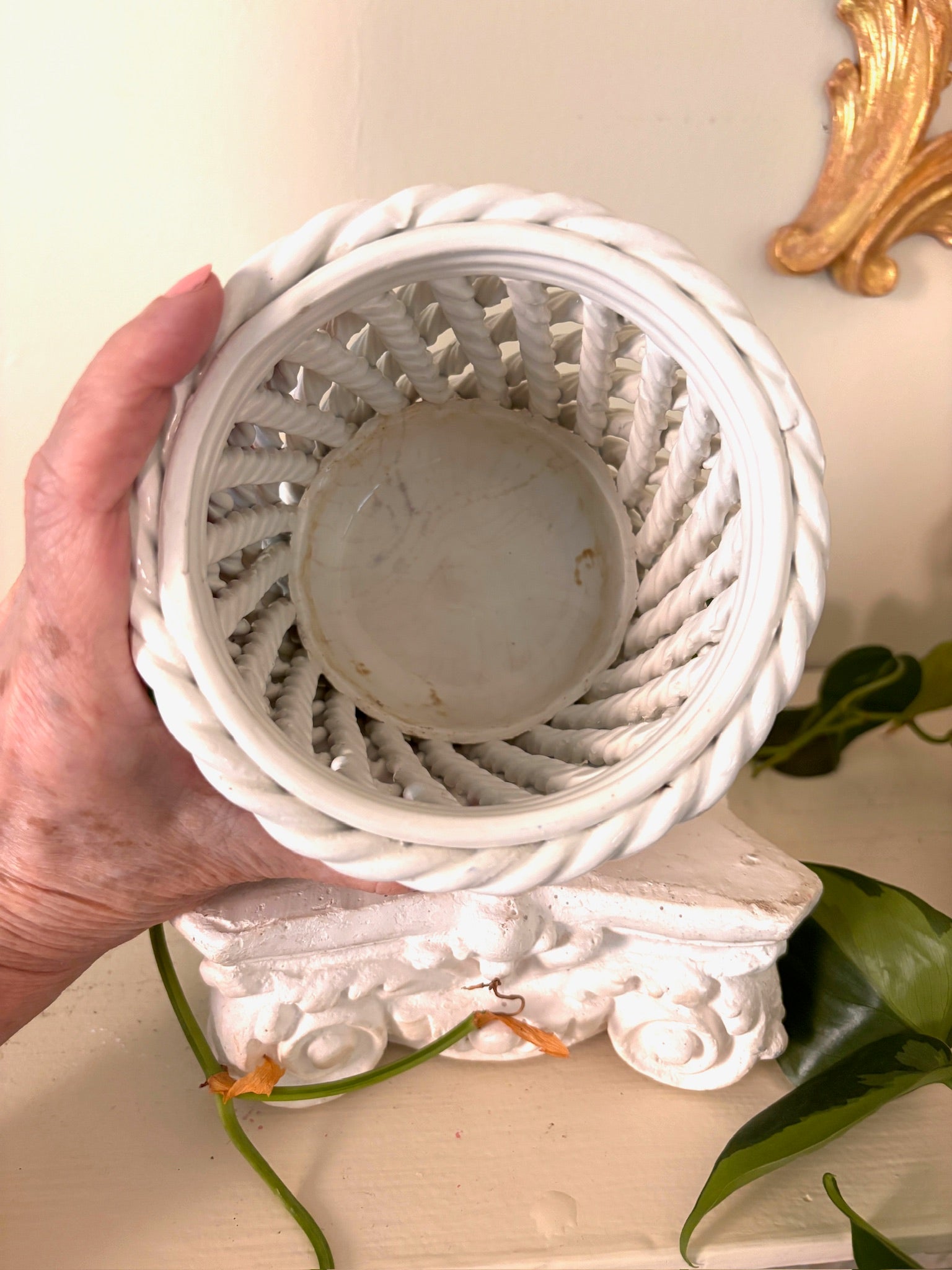 Top view inside the white ceramic rope-lattice basket showing the glazed base and open weave.